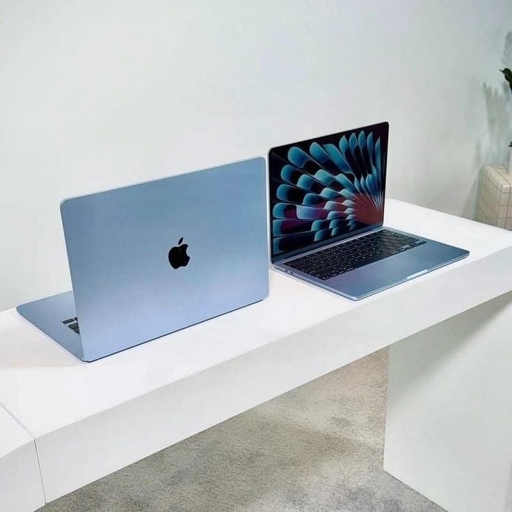 Two open MacBook notebooks side by side on a white surface